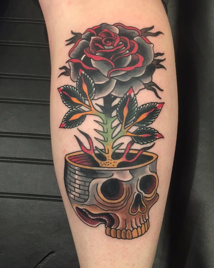 Rose growing out of a skull color tattoo by tattoo artist Jerry Martin II at Sacred Mandala Studio in Durham, NC.