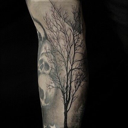 Alan Lott - forearm tattoo of a single backlit tattoo done in black and grey. 